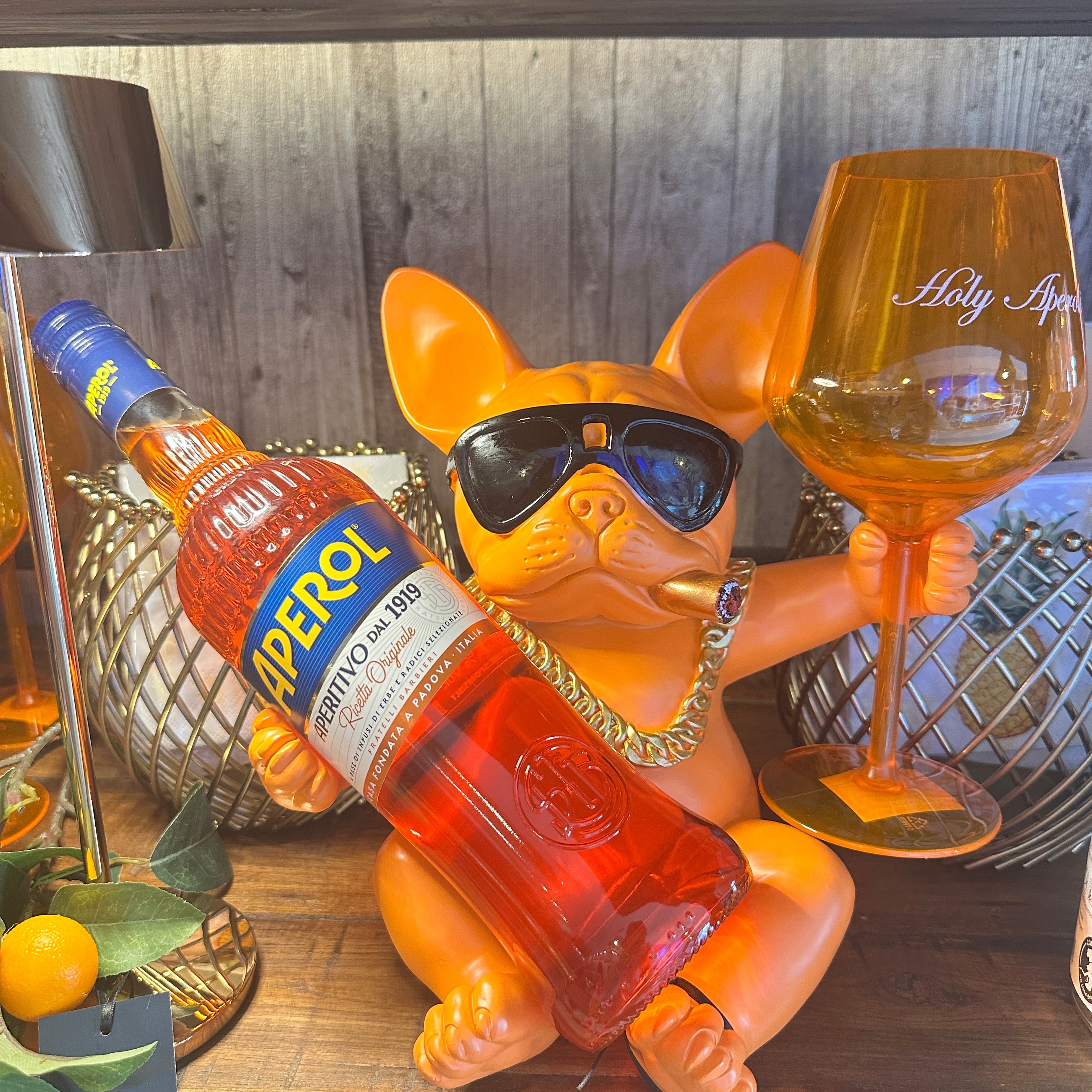 Oranger Flaschenhalter als Bulldogge mit Sonnenbrille und Zigarre  und Aperolflasche und Glas.